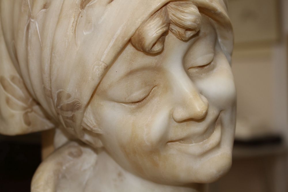 G. Pineschi (Italian c.1900). A carved alabaster and rose quartz bust of an Italian woman,